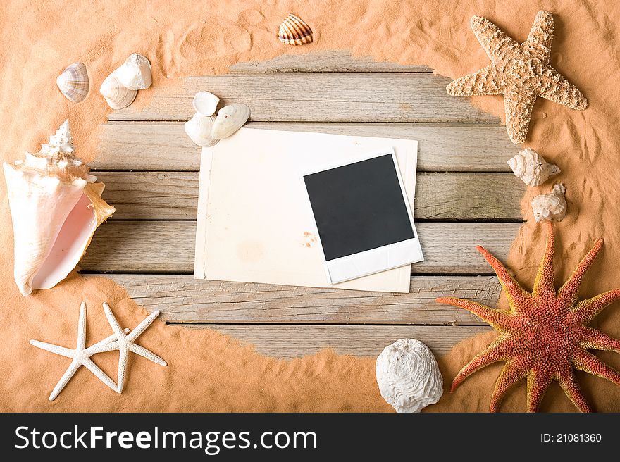 Sand and wood background with instant photo frame