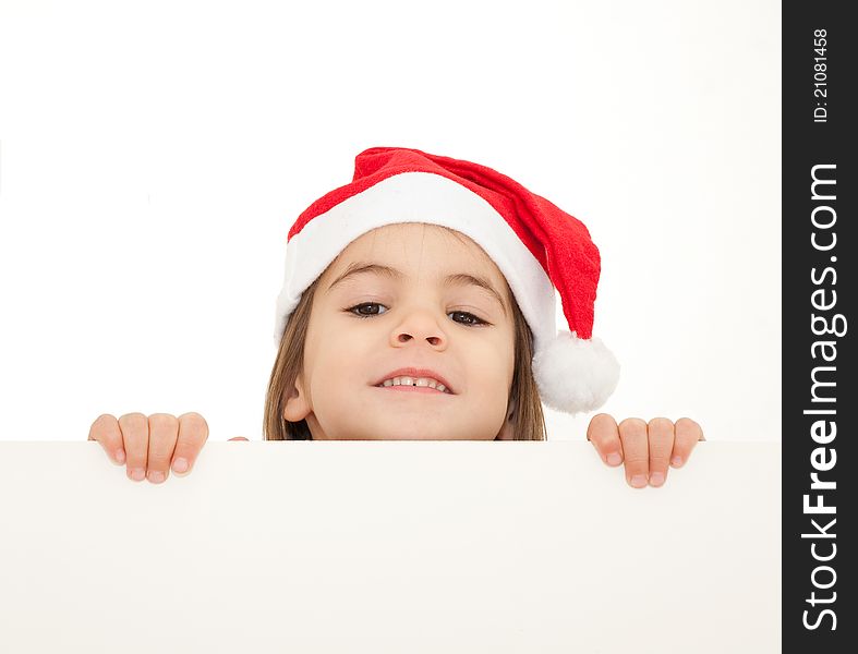 Little girl with santa hat holding a white banner isolated on white