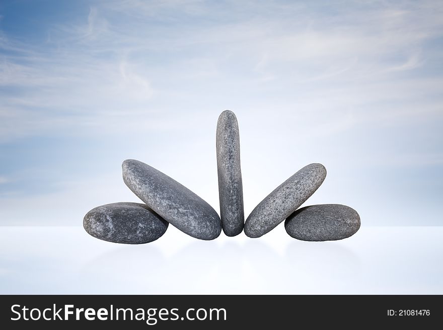 Zen Stones Tower on glass plate with sky background