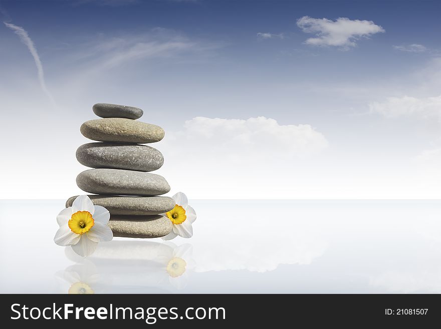 Zen Stones Tower on glass plate with sky background