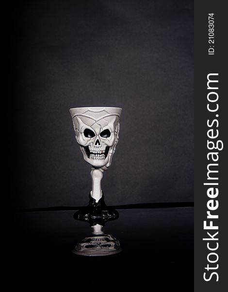 A skull goblet on a table with reflection. A skull goblet on a table with reflection