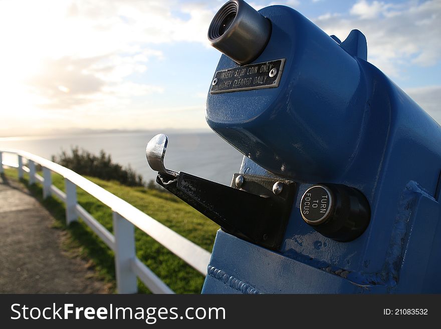 Spyglass with sunset and ocean in the background.