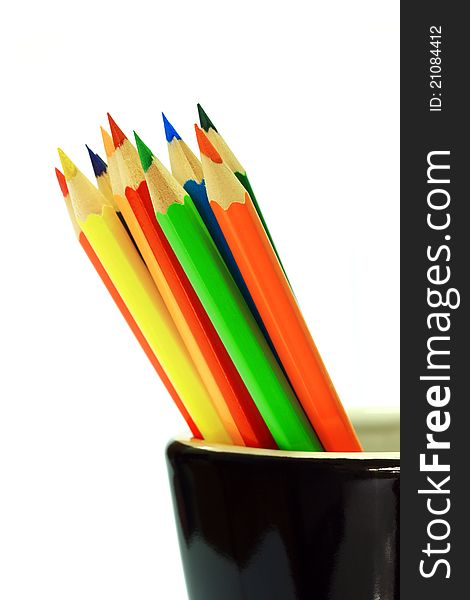 Various colour pencils on white background