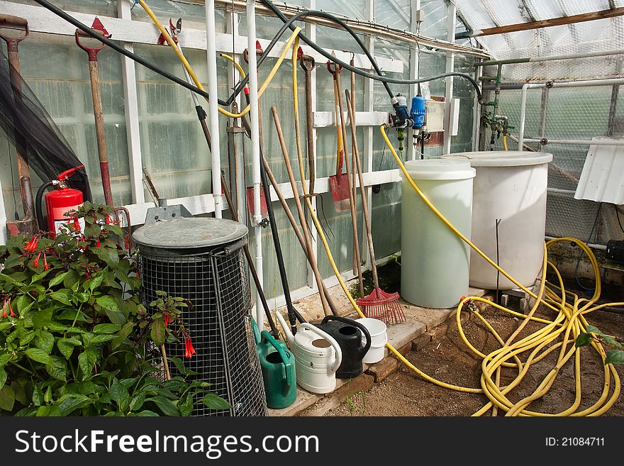 Gardening garden tools on a wall of a greenhouse agriculture hobby background