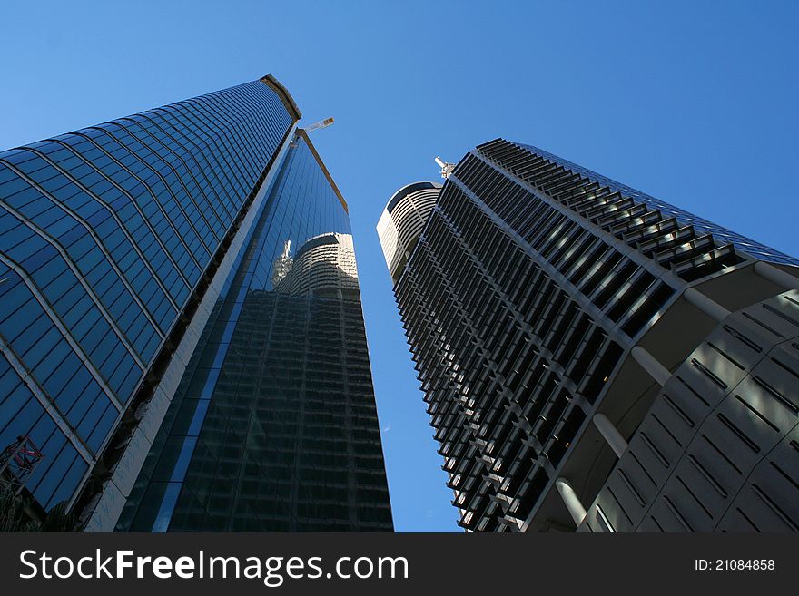 Skyscrapers with sunny sky in the background and few clouds.