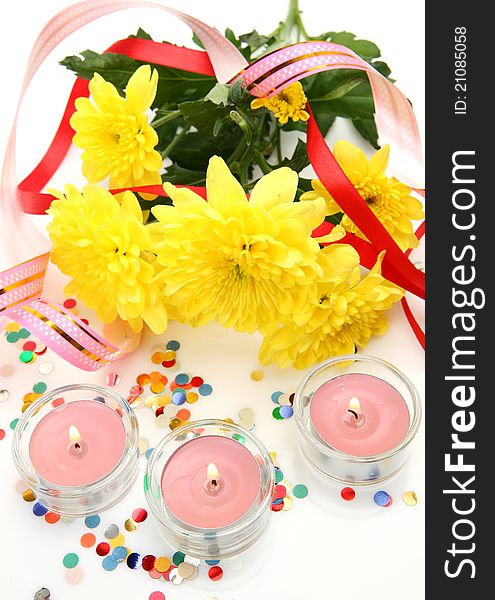 Flowers and candle on a white background. Flowers and candle on a white background