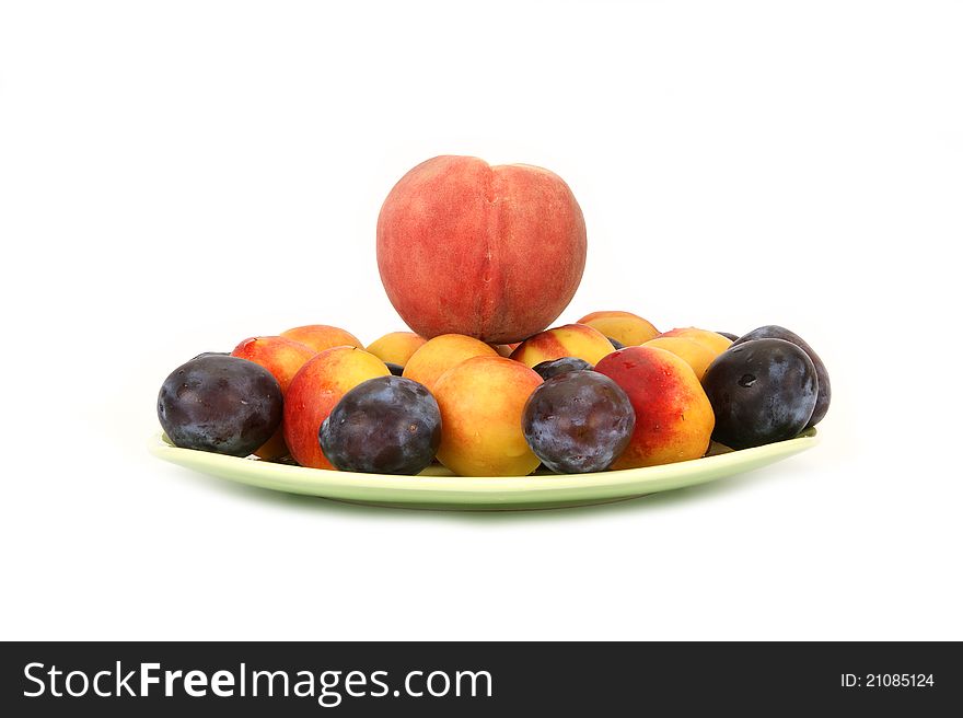 Still life with natural ripe plums and peaches on a white background