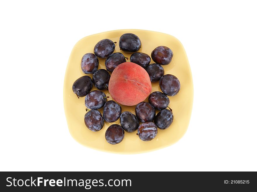 Still life with natural ripe plums and peaches on a white background