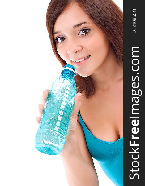 Thirsty young woman drinking water after fitness workout. Isolated on white. Thirsty young woman drinking water after fitness workout. Isolated on white