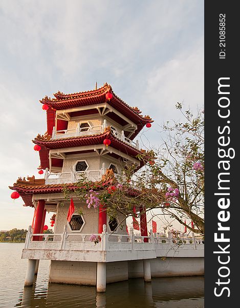 Single traditional Chinese pagoda built on water for good luck. Single traditional Chinese pagoda built on water for good luck.