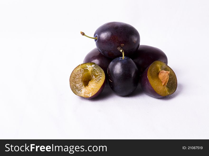 Purple plums on white background beautiful healthy