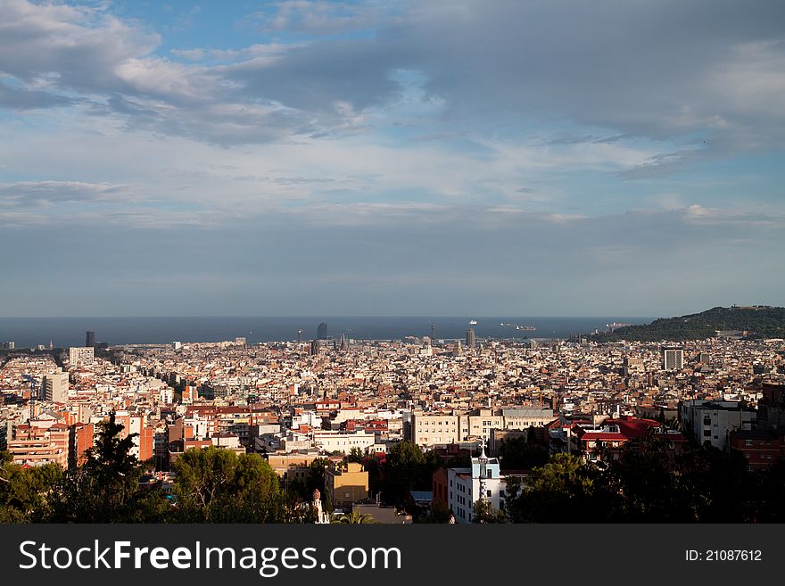 View of sunny Barcelona with sea and Montjuic mountain