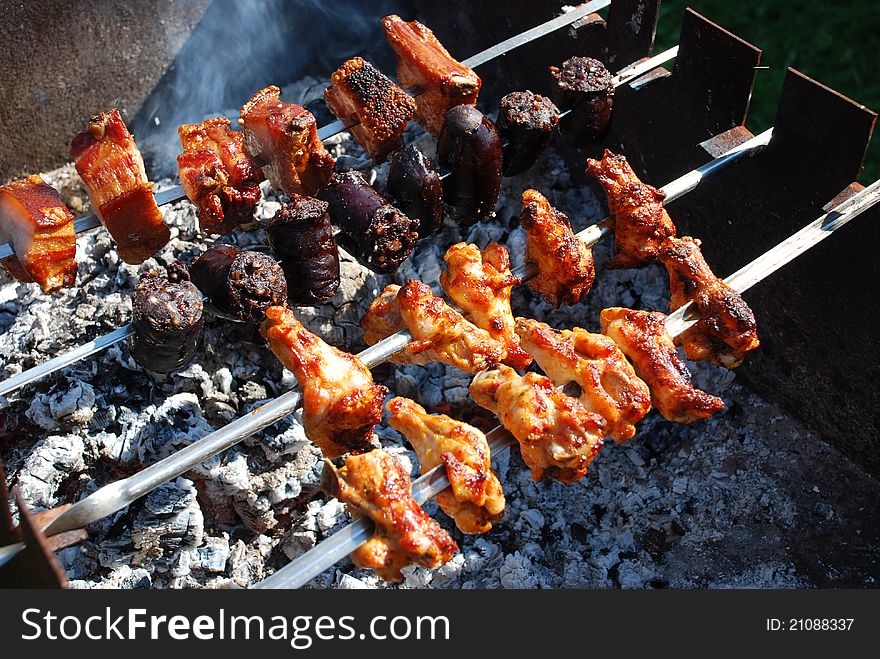 Chicken, Bacon and Blood Sausage on Barbecue Grill