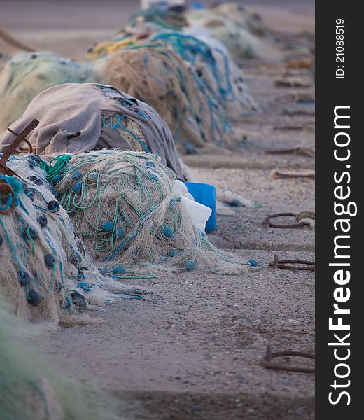 Piles of fishing nets on the harbour pier at Yumurtalik, Turkey.