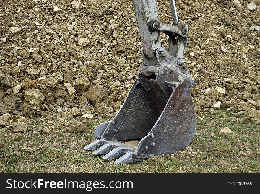 An excavator shovel, standing on the ground. An excavator shovel, standing on the ground