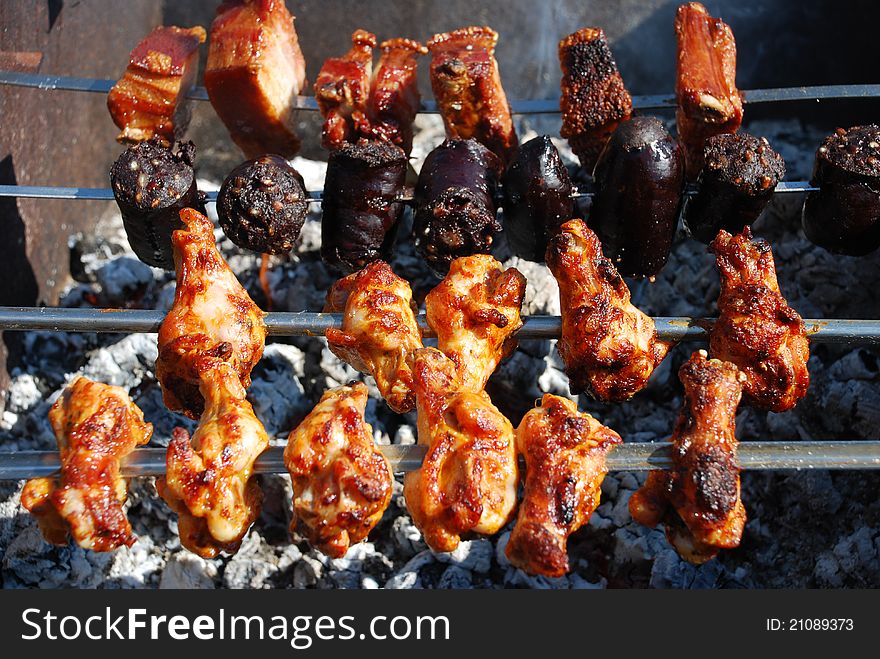 Chicken, Bacon and Blood Sausage on Barbecue Grill
