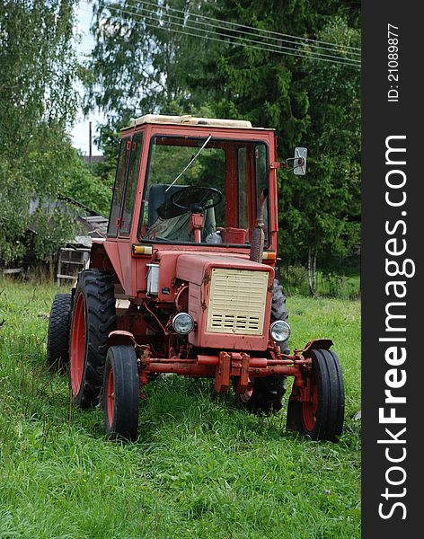 Old red tractor in Russia