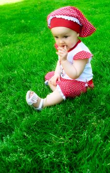 A Baby Girl On The Grass Stock Image