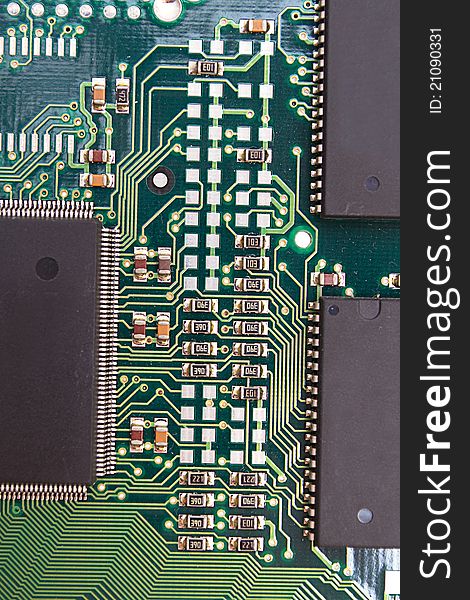 Green circuit board with components.