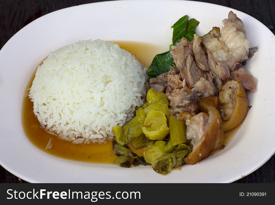 Pork Leg Stew with white rice on plate (Thai food).