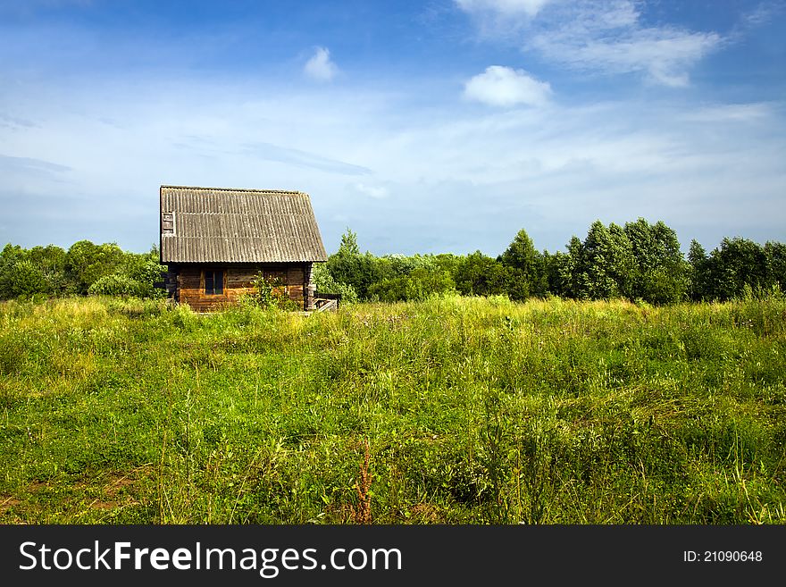 The small wooden house which is in the field, grassed