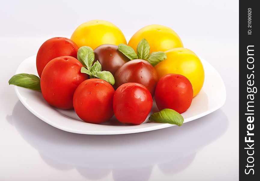 Variety of tomatoes with fresh basil