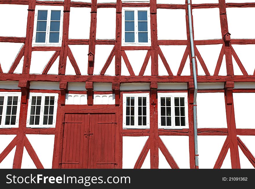 Architectural detail of a scandinavian house with visible red wooden beams. Architectural detail of a scandinavian house with visible red wooden beams