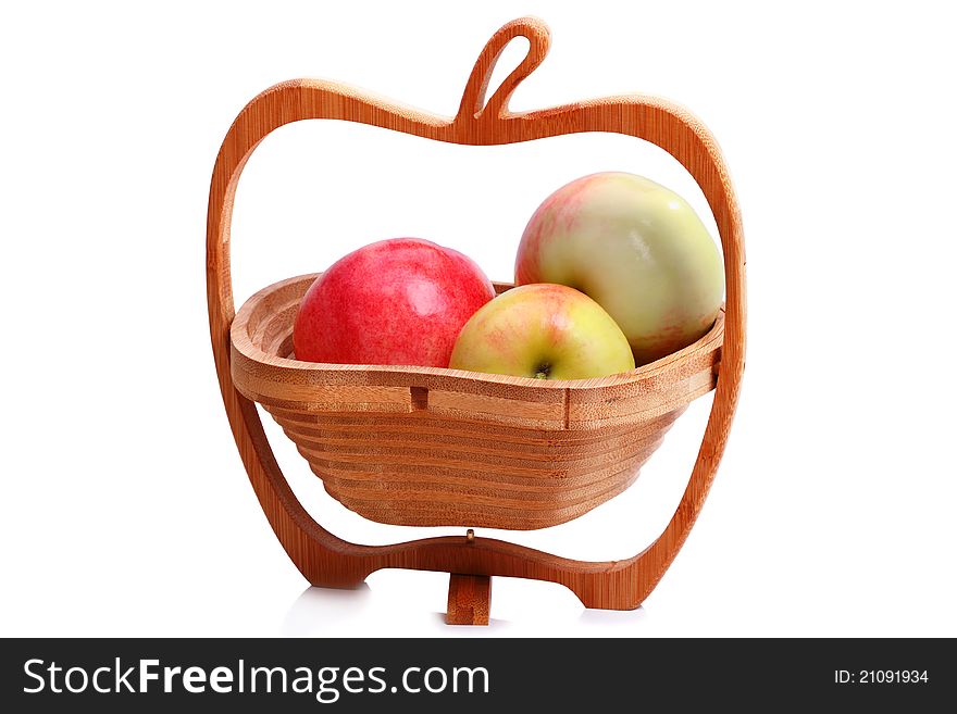 The original wooden vase in the shape of an apple and ripe apples. on white background. The original wooden vase in the shape of an apple and ripe apples. on white background