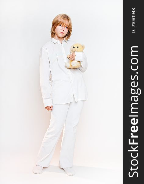 Girl in white looking with teddy bear overwhite. Girl in white looking with teddy bear overwhite