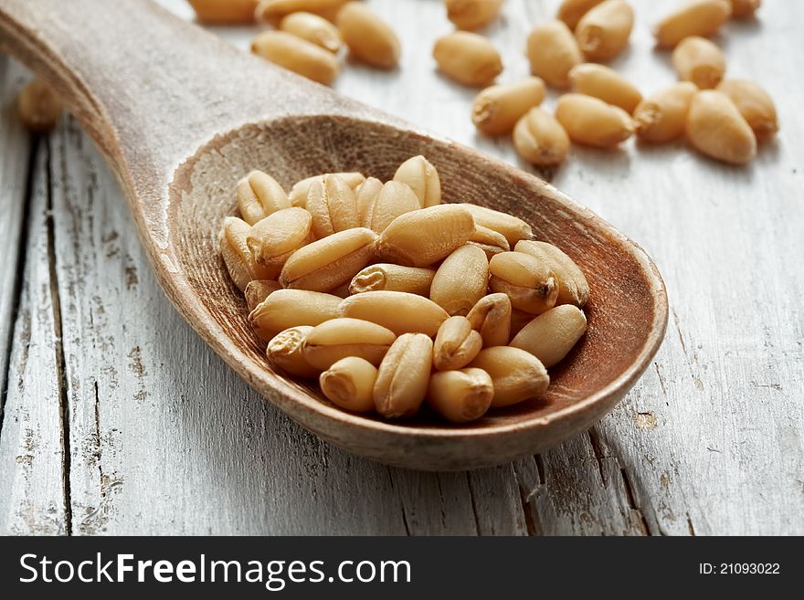 Sweet dry wheat on a wood spoon