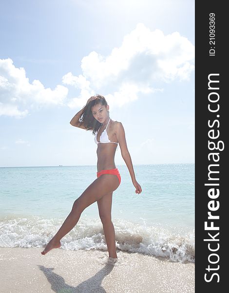 Asian Brunette Beautiful woman wearing bikini on the beach in Miami Beach. Asian Brunette Beautiful woman wearing bikini on the beach in Miami Beach