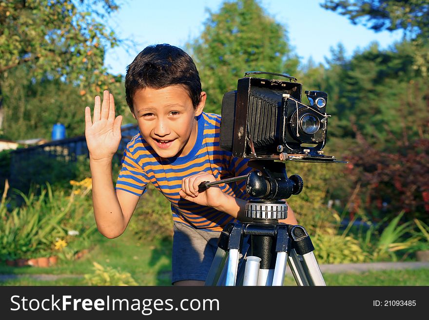 Boy with retro camera outdoors