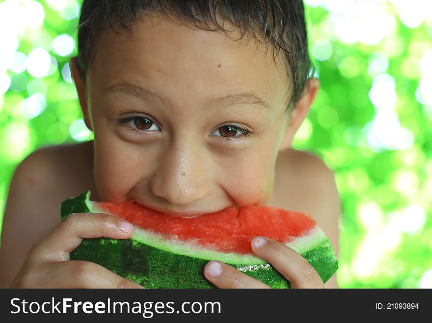 Little boy eating red watermelon