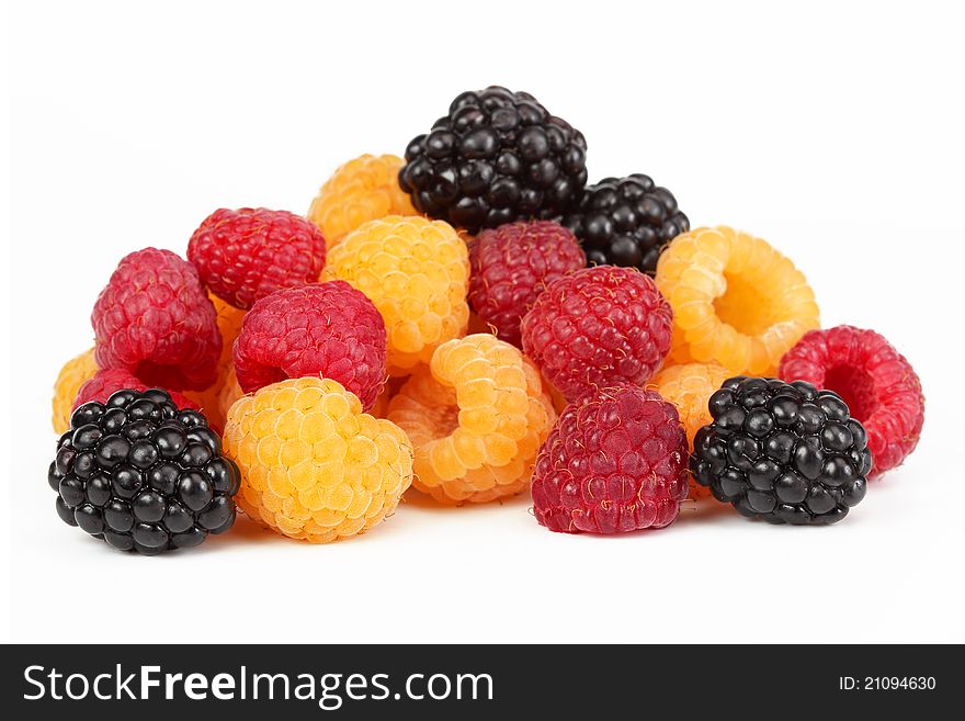 Berries ripe blackberry (dewberries) black with yellow and red raspberries on a white background. Berries ripe blackberry (dewberries) black with yellow and red raspberries on a white background