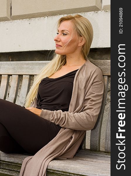 Woman sitting on a bench.