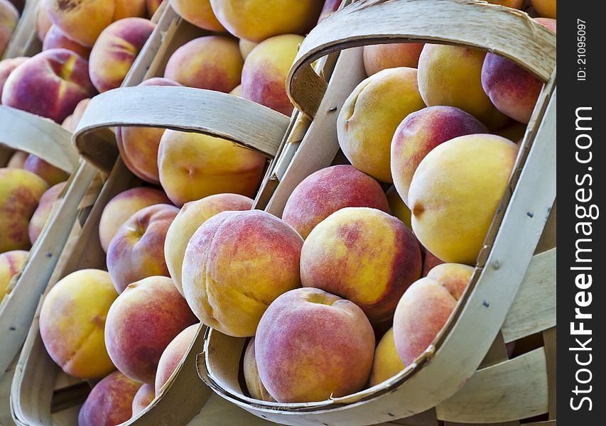 Fresh peaches in baskets at a market. Fresh peaches in baskets at a market