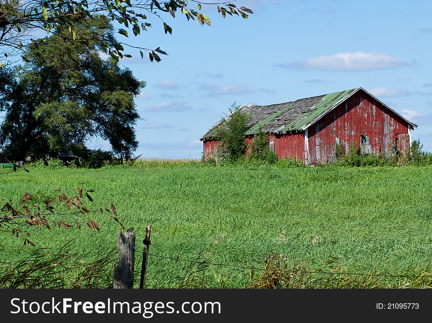 Picture of barn in field against blue sky. Picture of barn in field against blue sky.