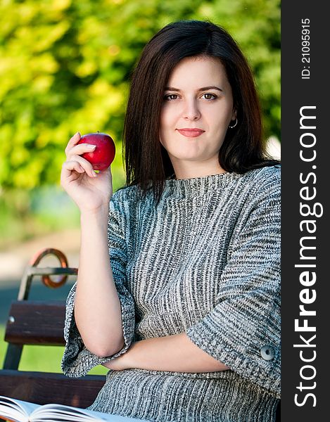 Portrait of a young female student with books at the campus