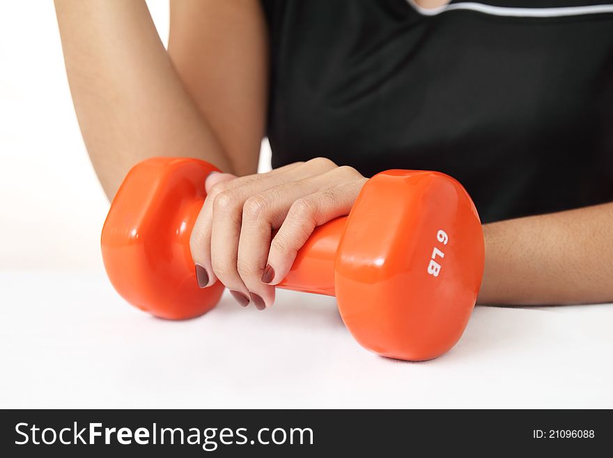 Close up of a woman with dumb bell on fitness concept.