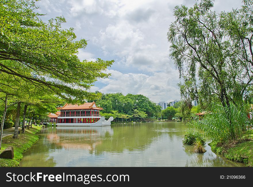 Photo of an old chinese building in beautiful natural environment with clouds and trees. Photo of an old chinese building in beautiful natural environment with clouds and trees