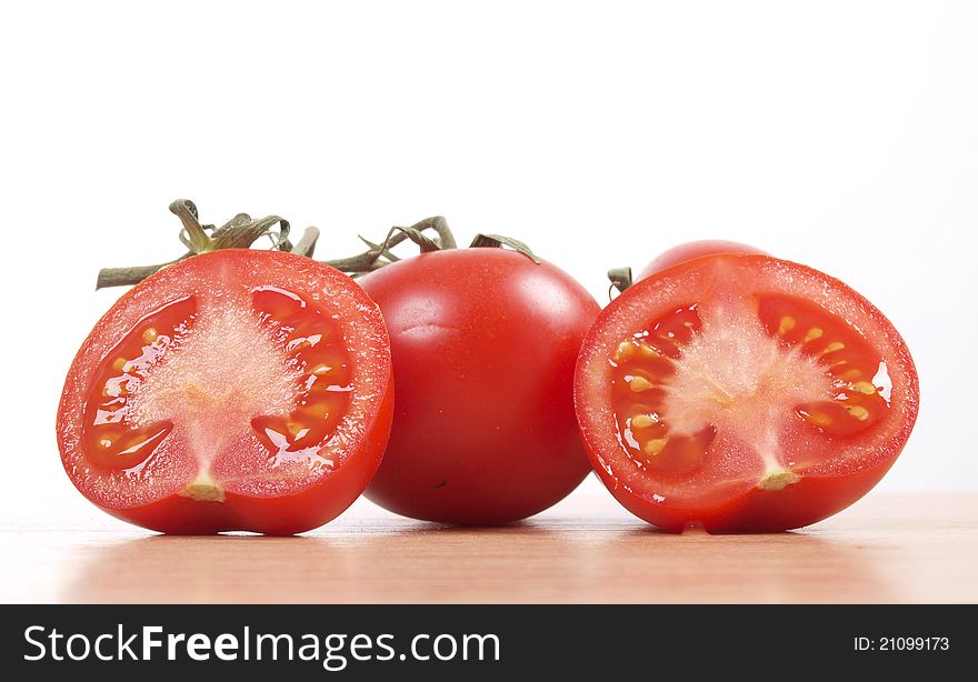 Color photo of red tomatoes on wood. Color photo of red tomatoes on wood