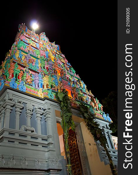 Main entrance of Indian temple with black background.