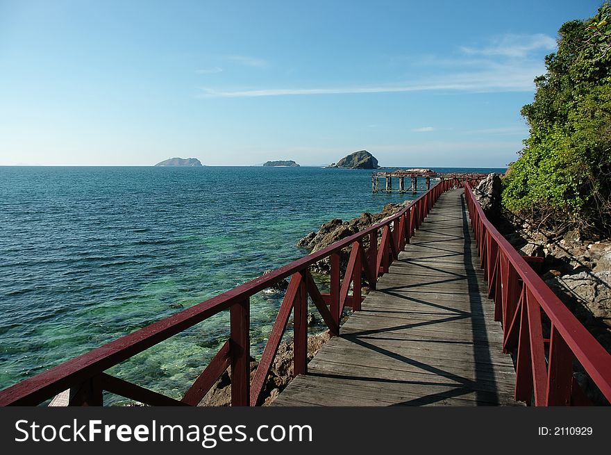 Wooden bridge at sea site with clear sky. Wooden bridge at sea site with clear sky