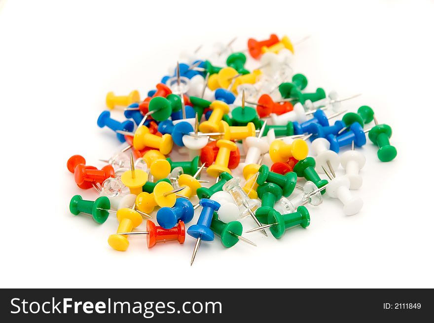 Colorful pushpins against white background