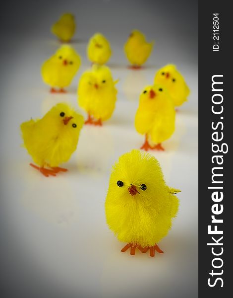 Yellow easter toy hens on the reflective background. Yellow easter toy hens on the reflective background