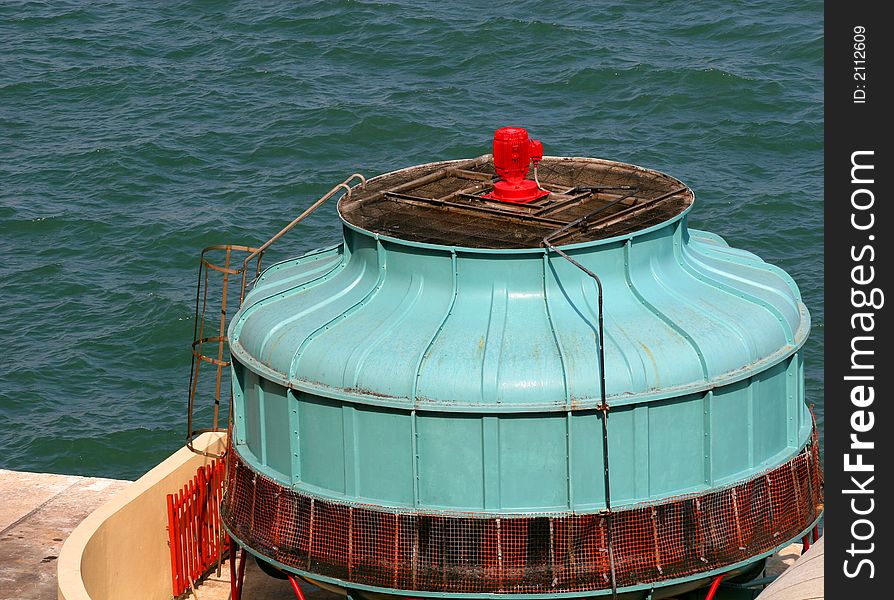 Industrial blue and red turbine on a shipping dock