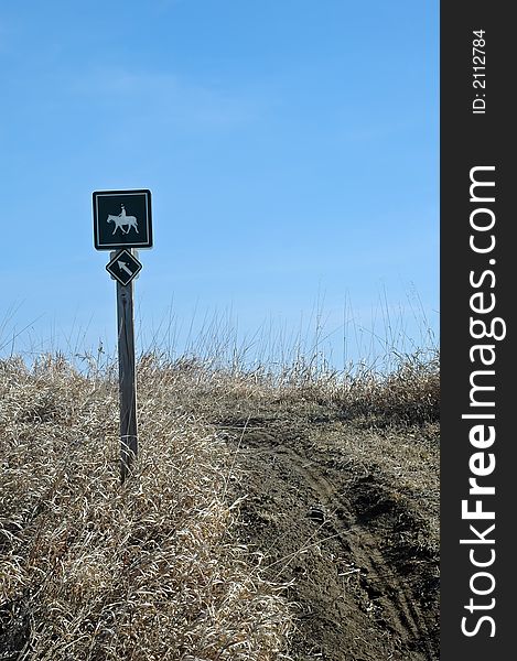 Green sign on trail to direct horse back riders. Green sign on trail to direct horse back riders.