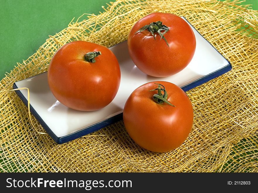 A photo of three tomatoes