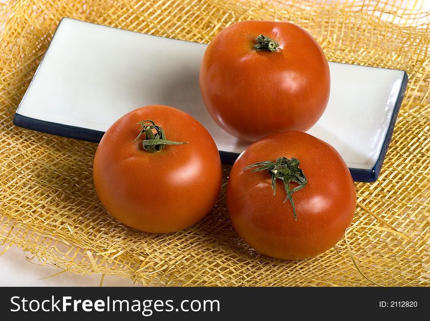 A photo of three tomatoes. A photo of three tomatoes