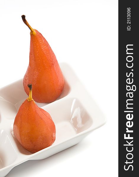 Close-up of two pears poached in red wine